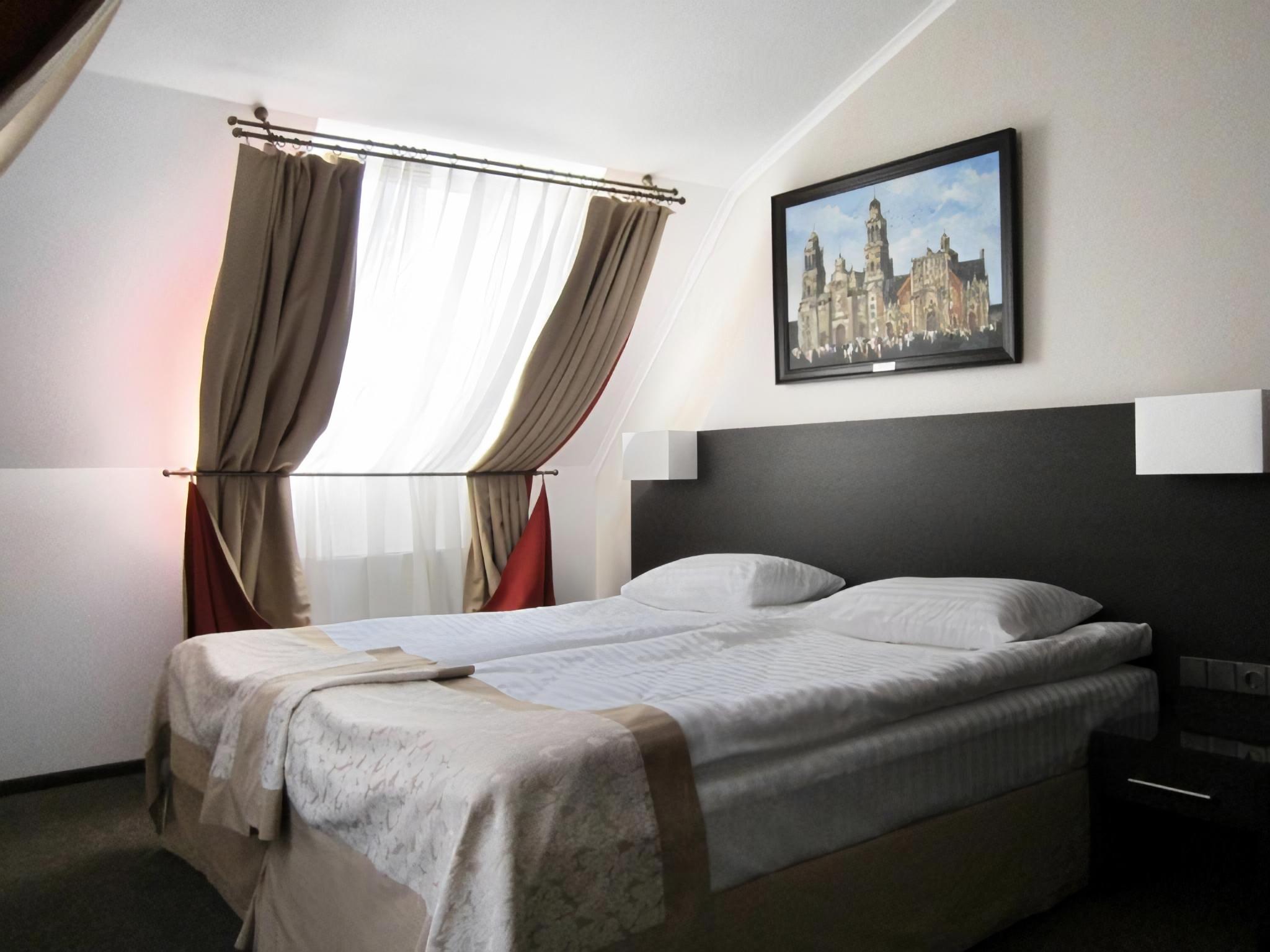 A large room with a king bed at the Reikartz Hotel Kharkiv